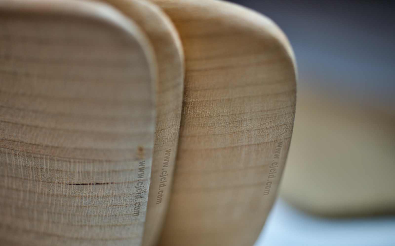 Close up on the tip edges of three cooking spatulæ, made from single block of solid Sakura wood, for right handed usage