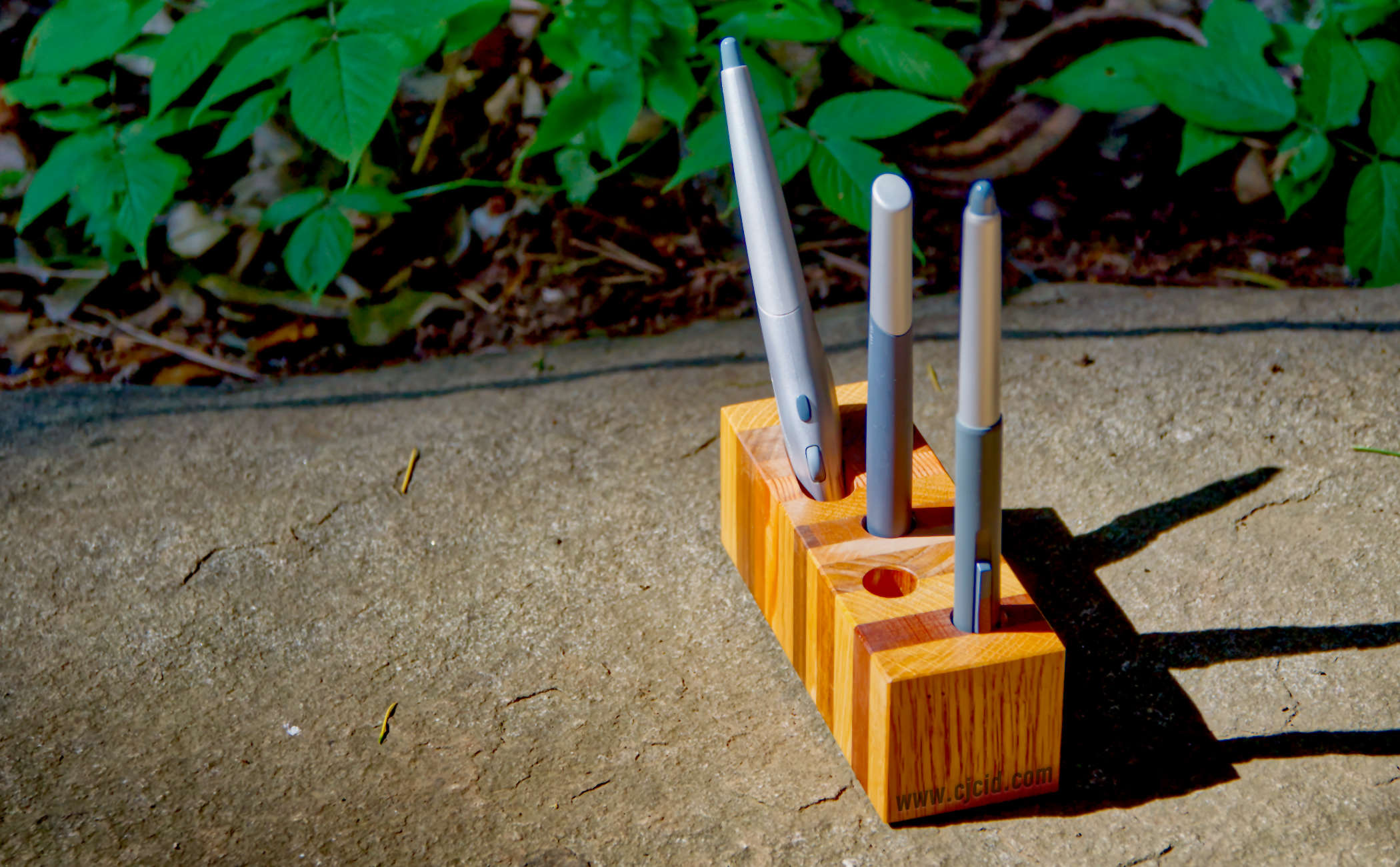 Alternative side view of the handmade wooden pen holder “CJ Triplet Cuboid”, with 3 Wacom styluses in place